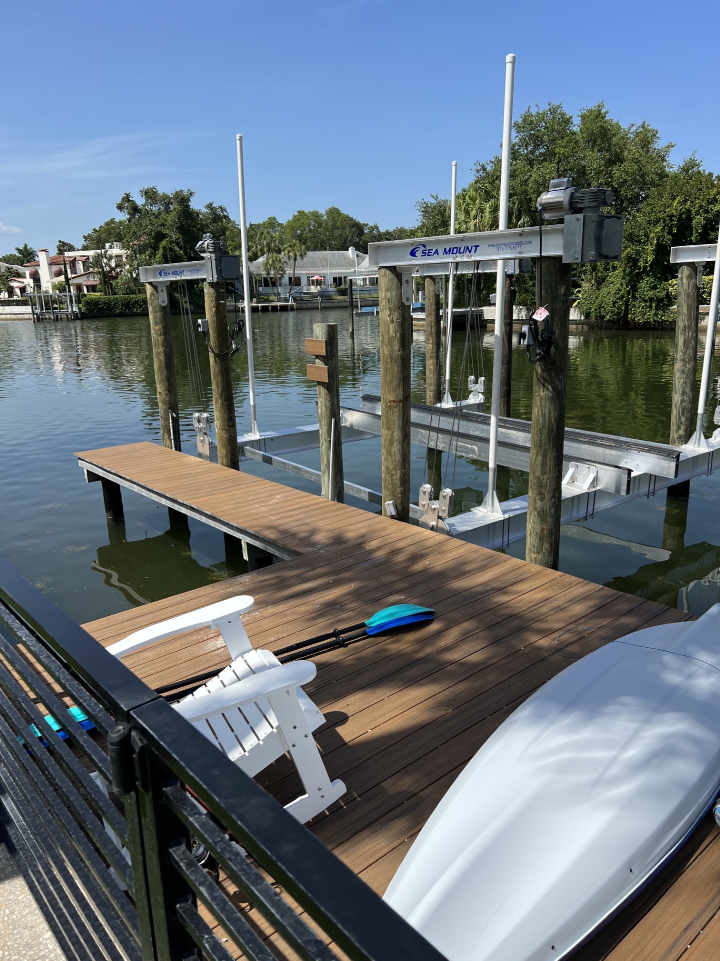 Boat raised on a Sea Mount lift beside a Tampa Bay dock