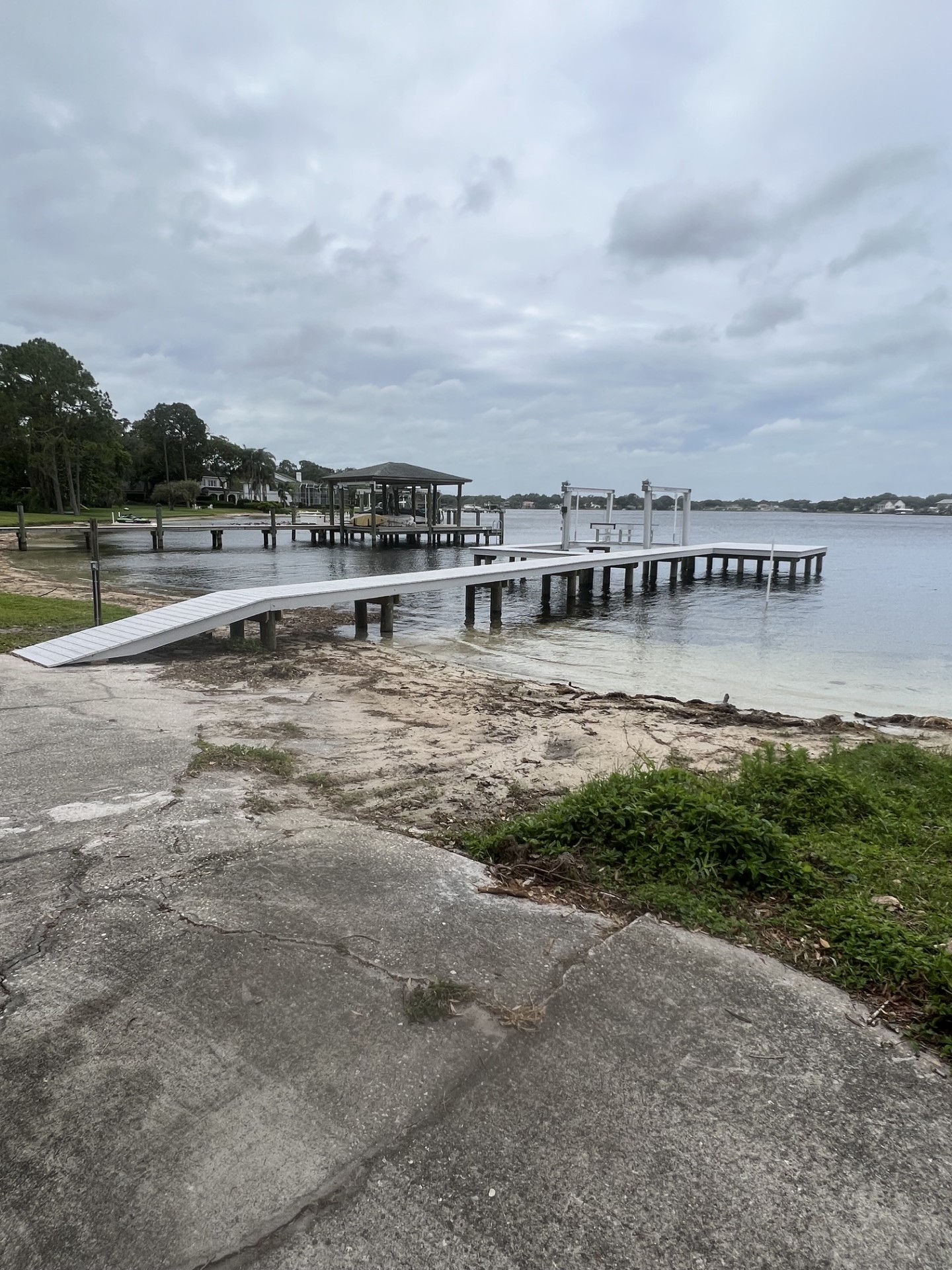 Boat lift and dock beside a waterfront residence
