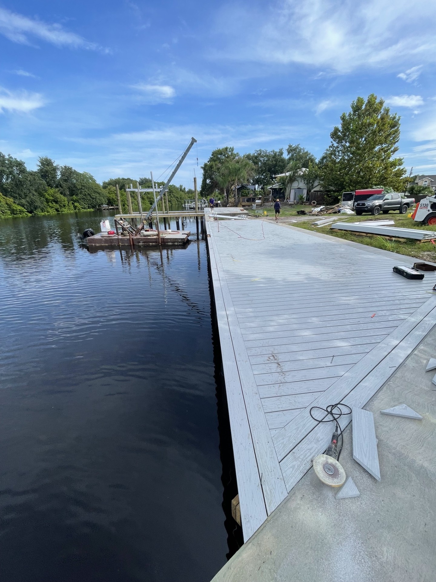 Marine crew working from a barge on a dock build