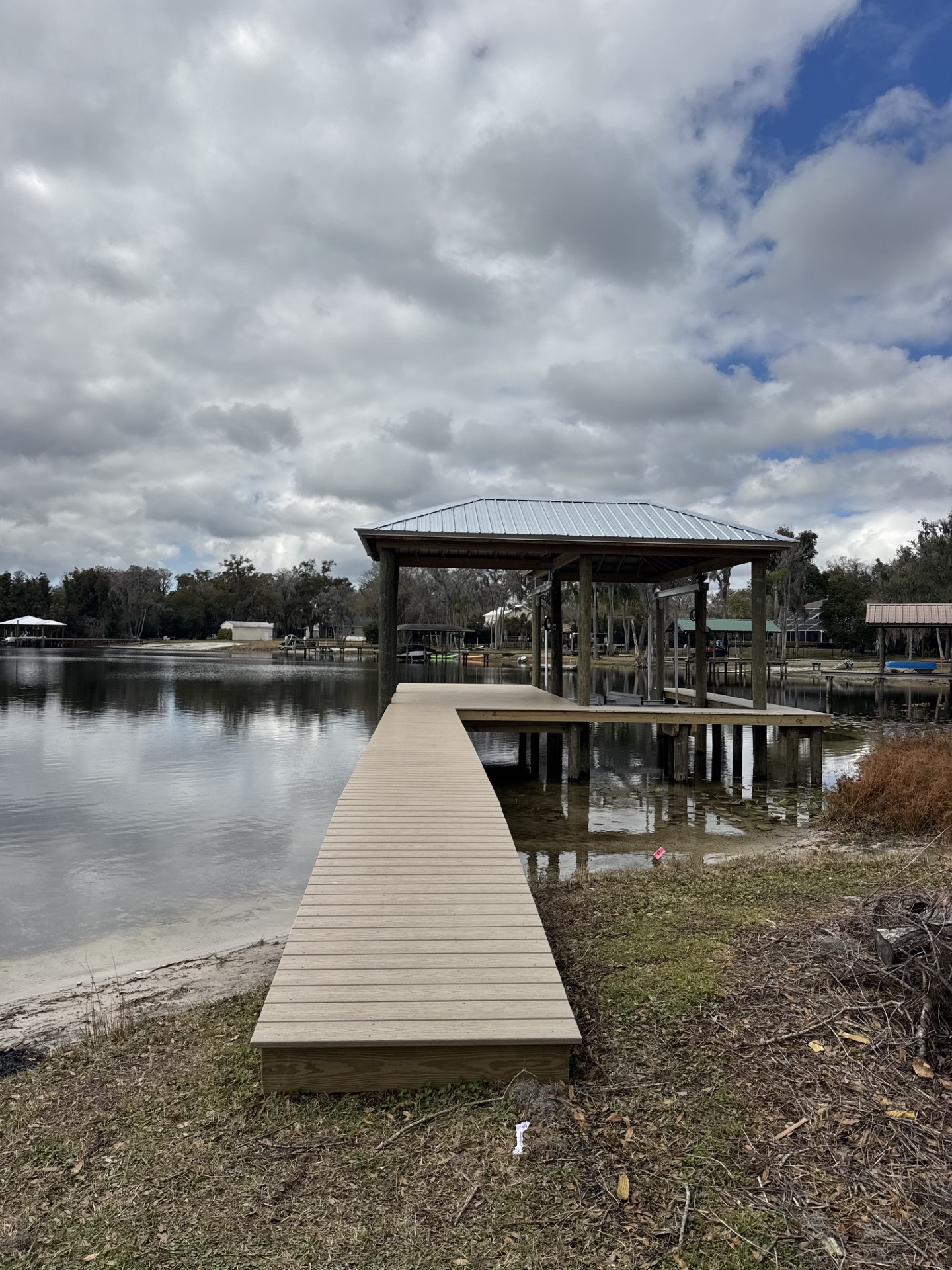 Covered boat dock with metal roof on a Florida lake