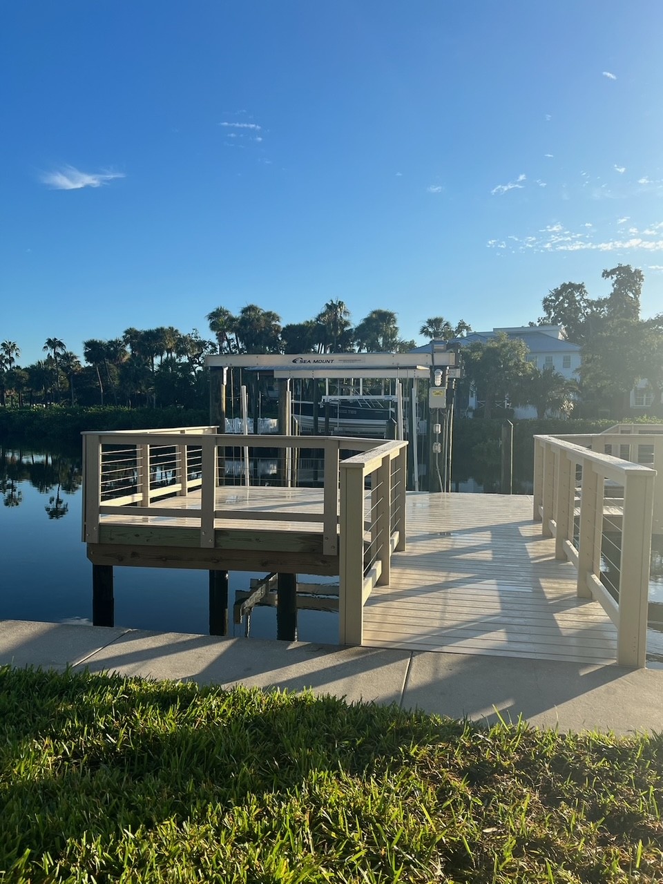 New composite dock walkway leading to a boat house