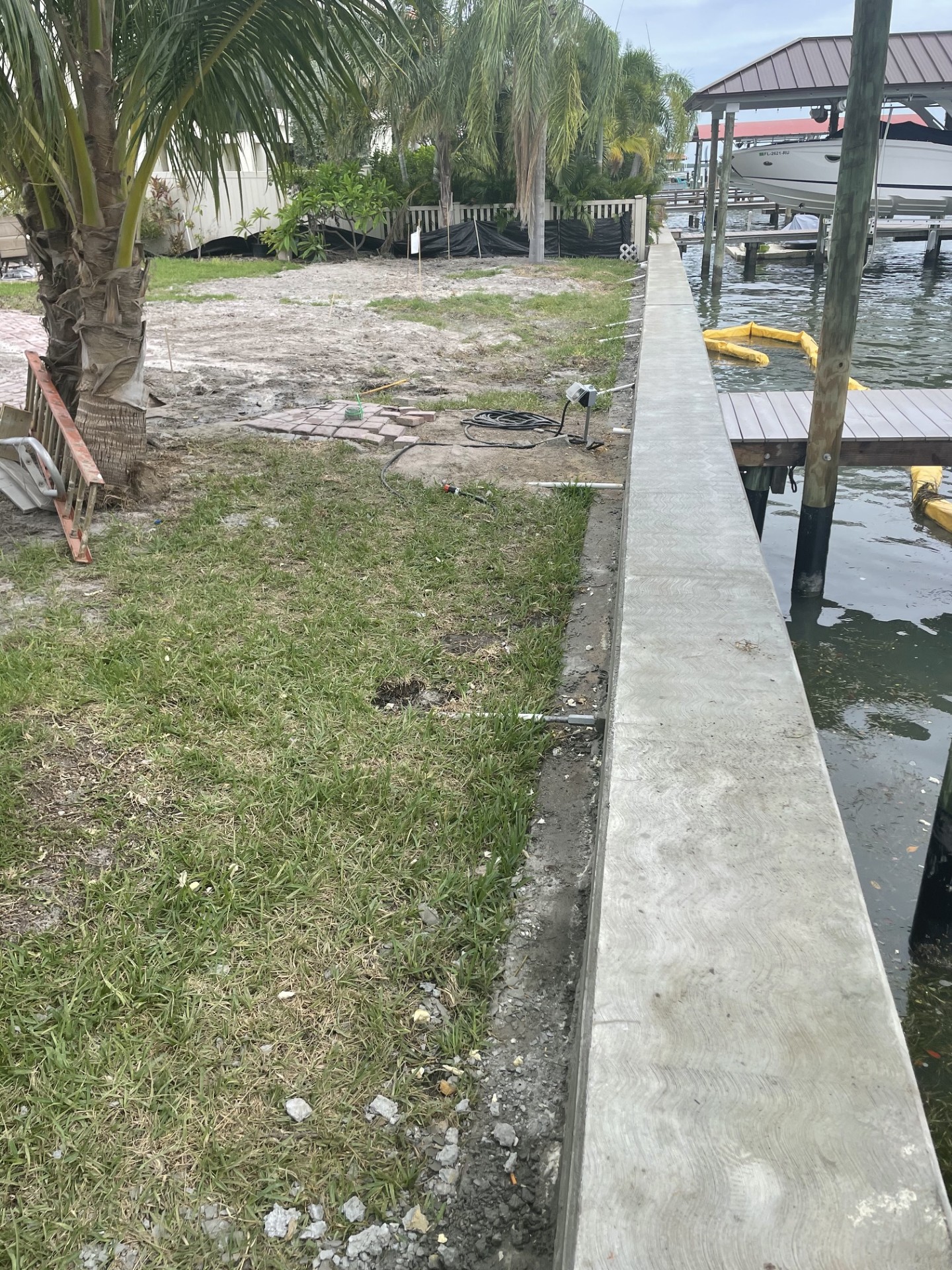 Finished seawall cap beside a residential lawn