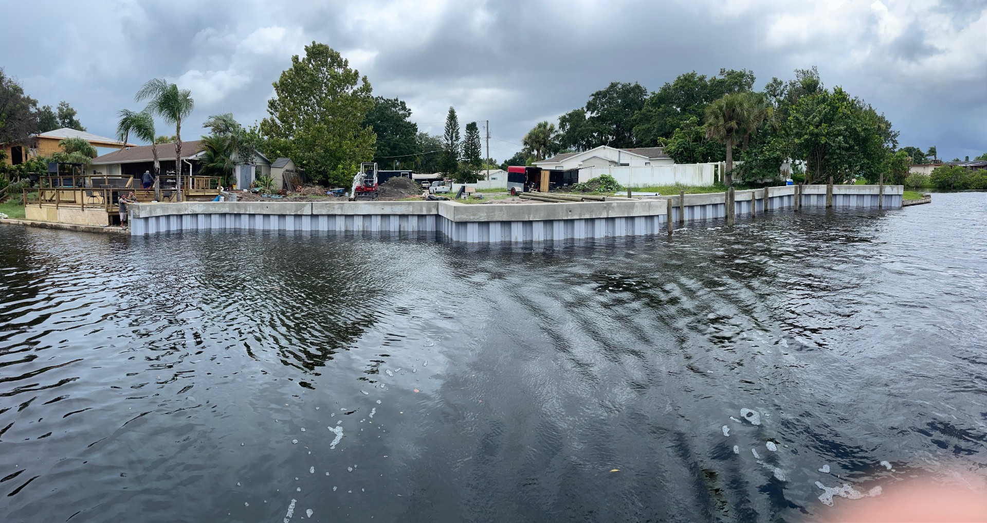 Finished concrete seawall protecting a waterfront property